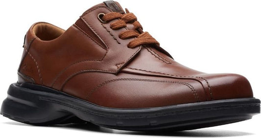 A brown leather lace-up dress shoe with a black sole.