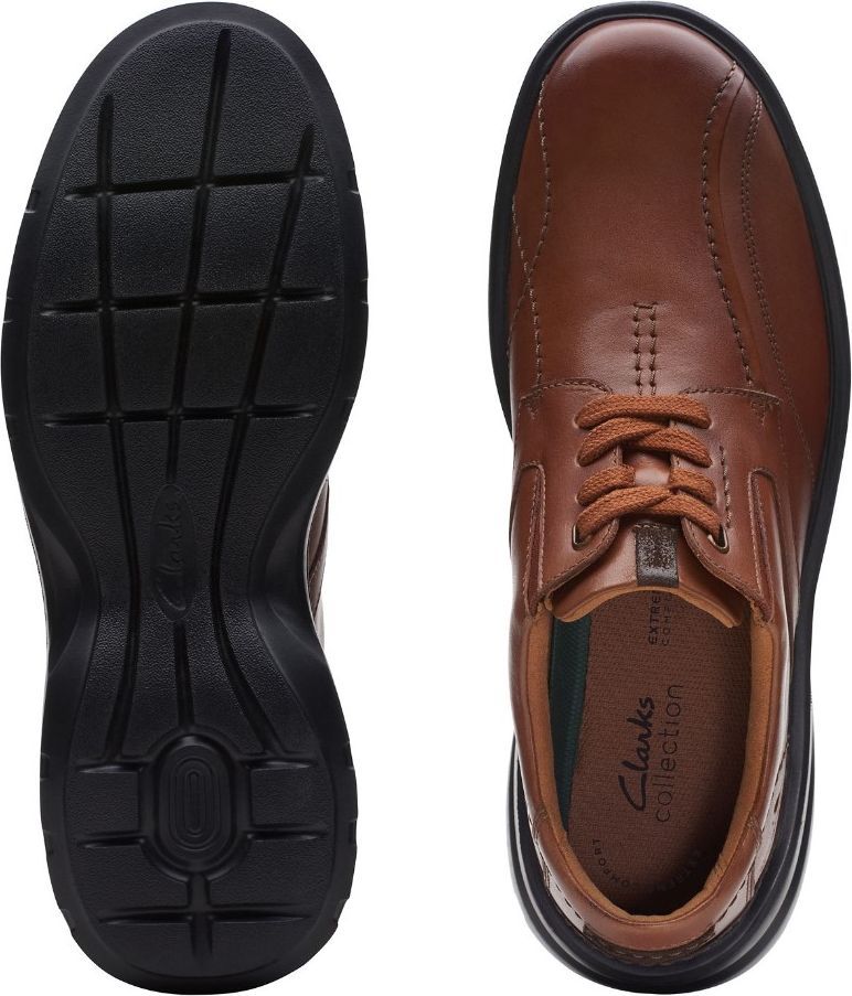 Top-down view of a brown leather dress shoe, showing a black sole with horizontal grooves, and shoelaces.