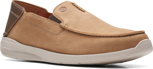 A tan slip-on shoe with a white sole.