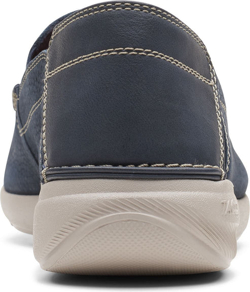 Back view of navy blue slip-on shoe with off-white sole.