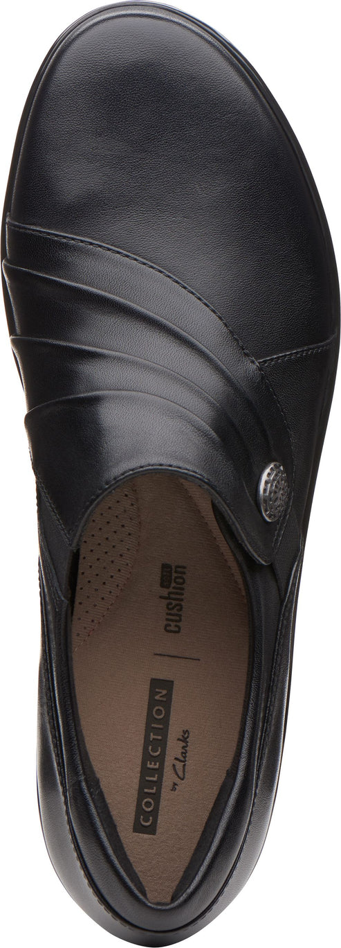A close-up shot showcases a sleek, black slip-on shoe, with its insole clearly revealing "COLLECTION by Clarks" and "Cushion" branding.