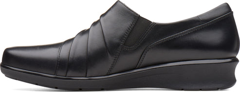 Black leather slip-on shoe with low wedge heel.