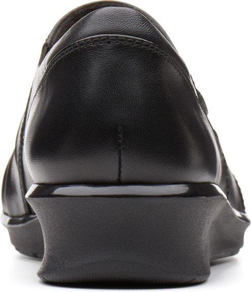 Close-up back of a black leather shoe with a low wedge heel.