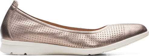 A bronze, perforated slip-on shoe with a white sole.