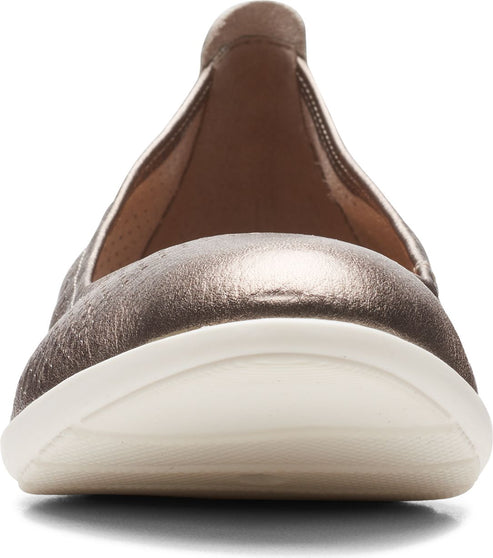 Close-up of a rose-gold ballet flat with a white sole and rounded toe.