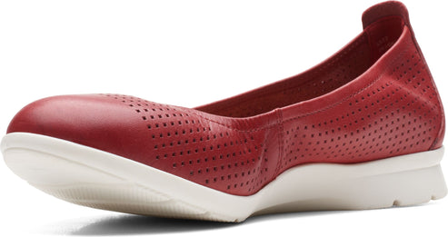 Red perforated leather ballet flat with a white sole.