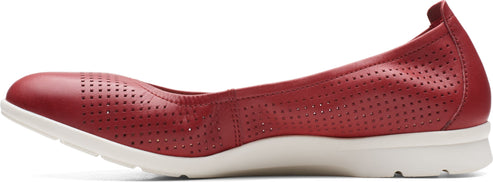 A red leather flat shoe with perforated details and a white sole.