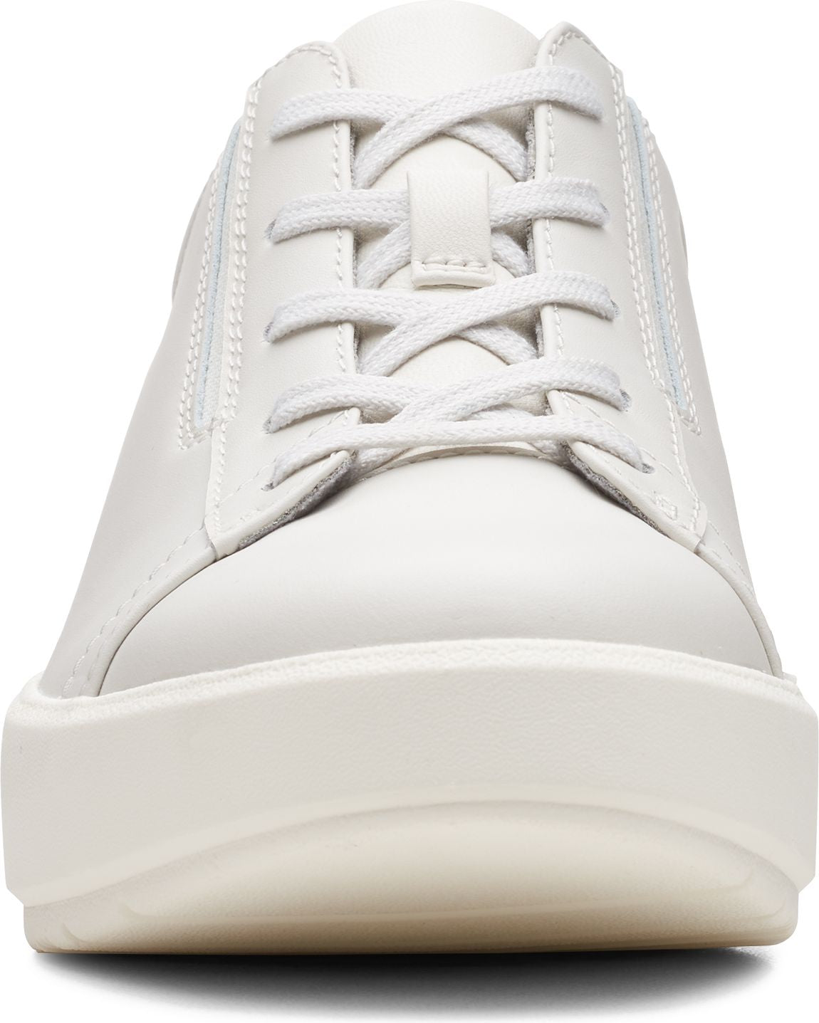 Front view of a white sneaker with white laces and a thick white sole.