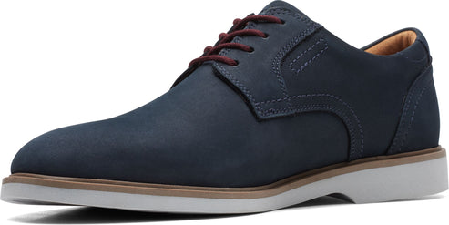 A blue leather dress shoe with brown laces and a white sole.