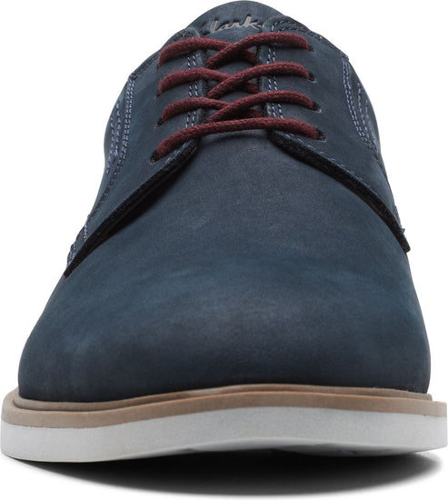 Front view of a blue leather dress shoe with red shoelaces and a white and brown sole.