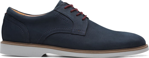 Navy blue dress shoe with red laces and a white sole.