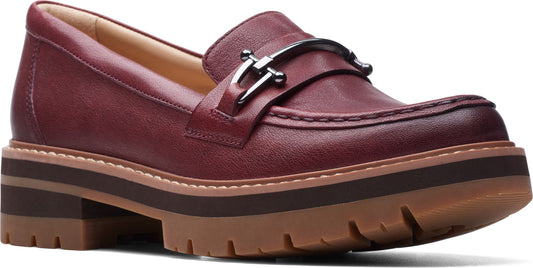 Burgundy leather loafer with metallic hardware on a lug sole.