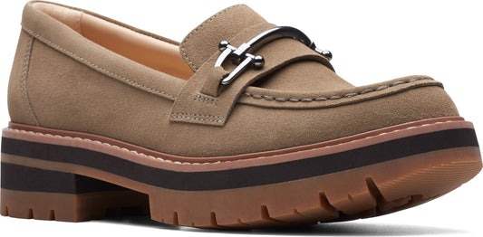 Tan loafer with a silver horse-bit style buckle and thick lug sole.