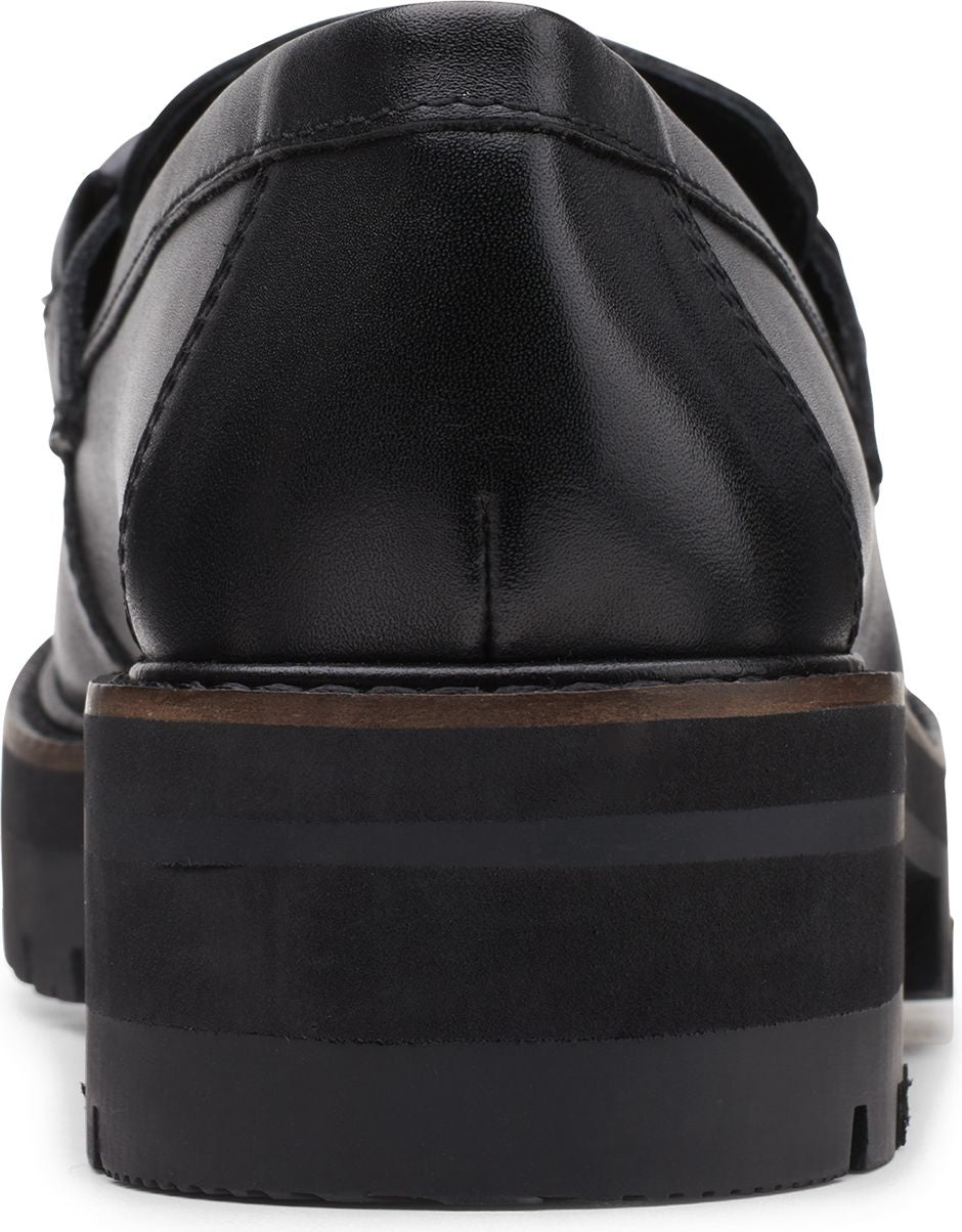 The back of a black, leather platform loafer with a lug sole.