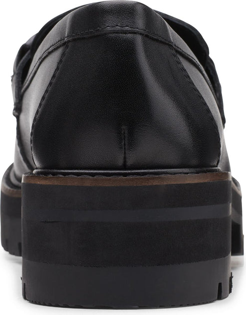 The back of a black, leather platform loafer with a lug sole.