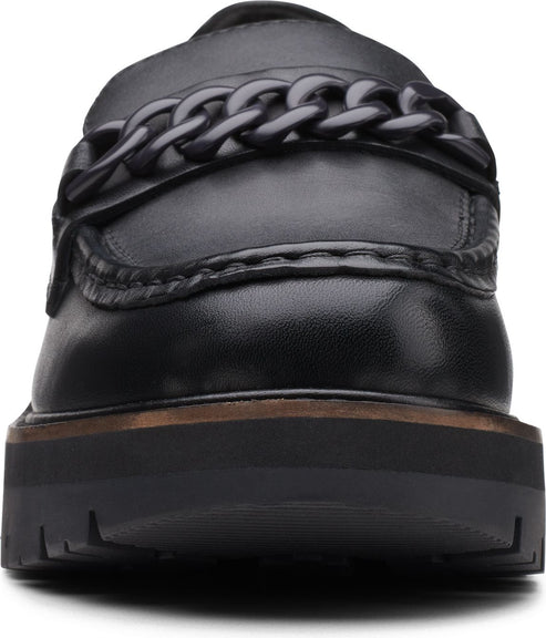 Black leather penny loafer with a thick decorative chain across the vamp and a substantial lug sole.