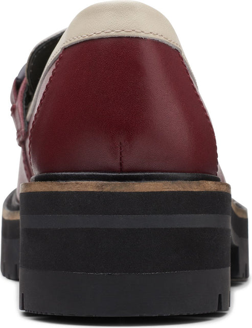 Rear view of a red and white shoe with a thick, black sole.