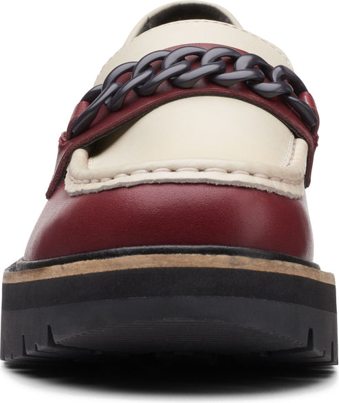 Front view of a lug-soled loafer featuring a burgundy, cream, and black chain design.