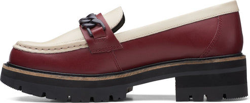 Lug-soled two-tone loafer with chain detail.