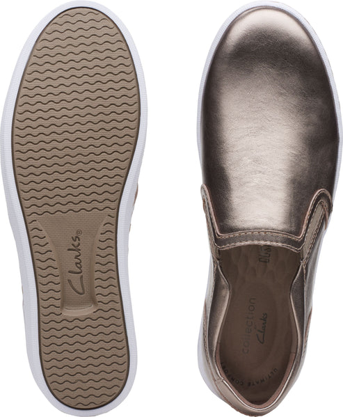 A pair of slip-on sneakers, one showing a tan ribbed sole and the other showing the shoe's metallic copper top.