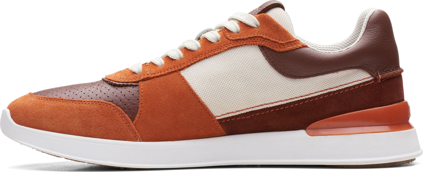 A brown leather sneaker with white laces and a white sole.