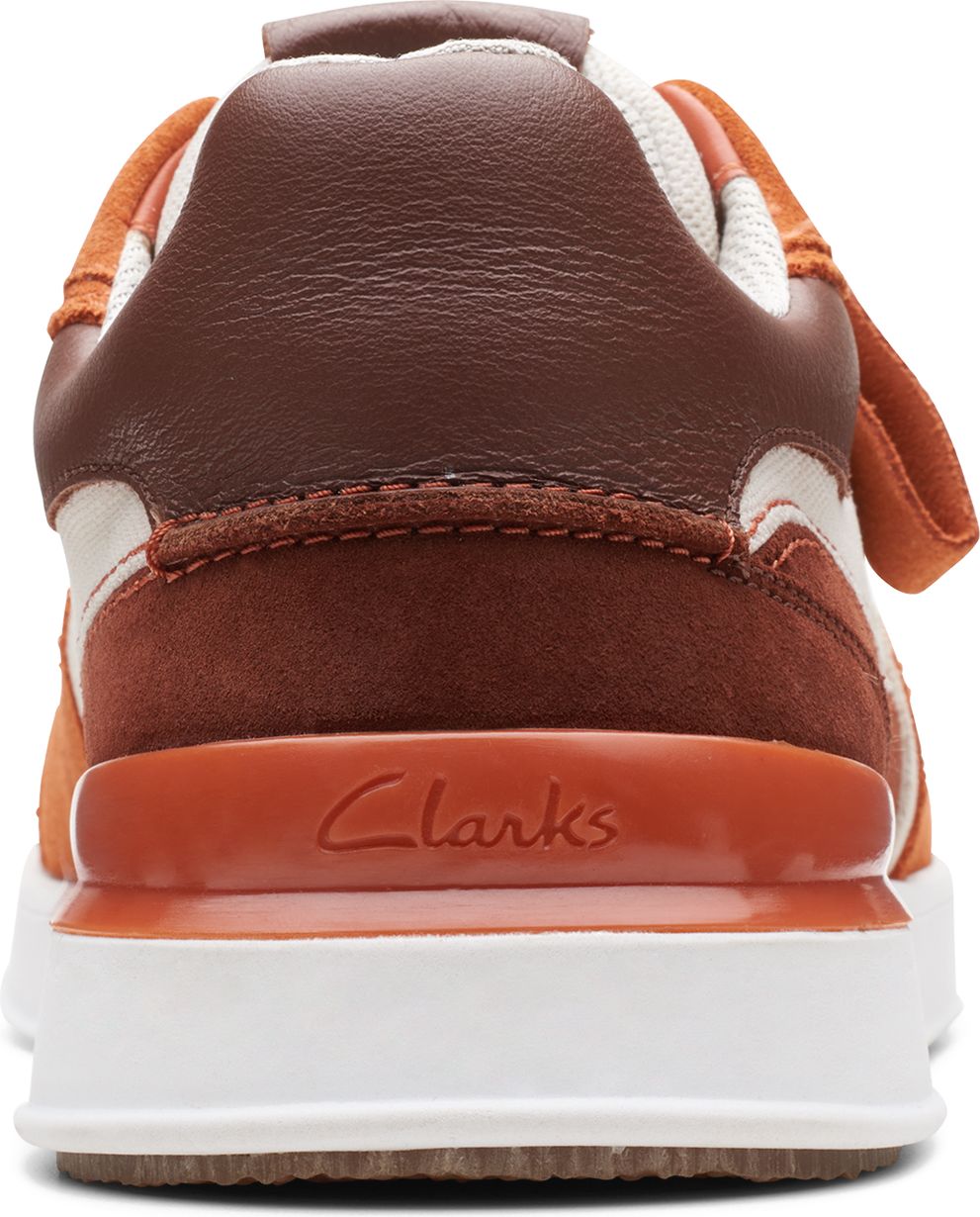 Back view of a two-toned brown and orange shoe with a white sole featuring the text "Clarks".