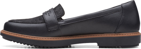 A black leather loafer with a decorative strap.
