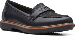 A black leather loafer with a dark textured top and a thick sole.