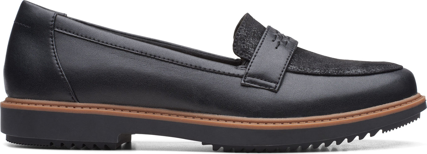 Black loafer with textured inlay on top.
