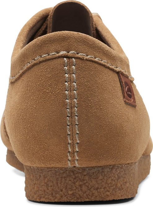 Tan suede shoe from the back showing stitching and a brown leather brand patch.
