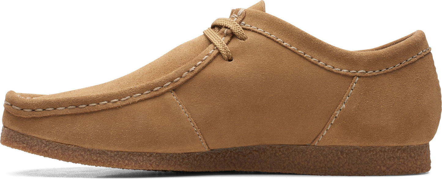 A tan suede loafer with rounded toe, lace up closure, and a crepe sole.