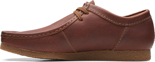 A brown leather loafer with brown shoelaces.