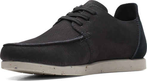 Dark gray, moc-toe shoe with laces and a speckled off-white sole.