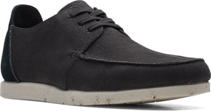 Low cut black shoe with laces and tan sole.