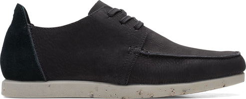 A black leather shoe with matching laces and a contrasting black suede heel and light-colored speckled sole.