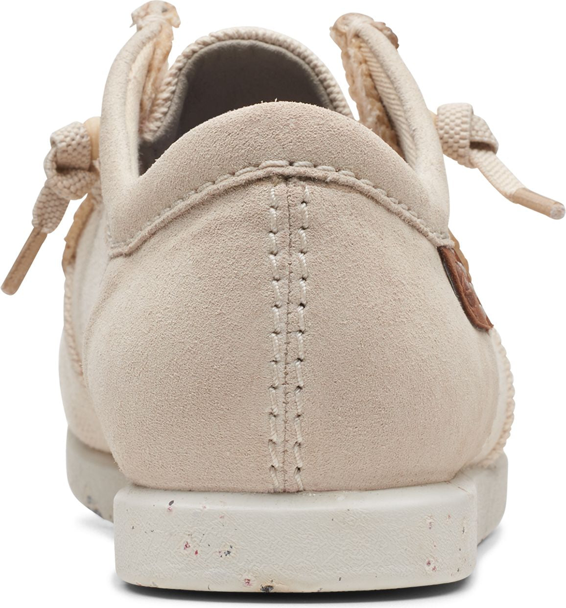 Rear view of beige casual shoe with suede upper and speckled sole.