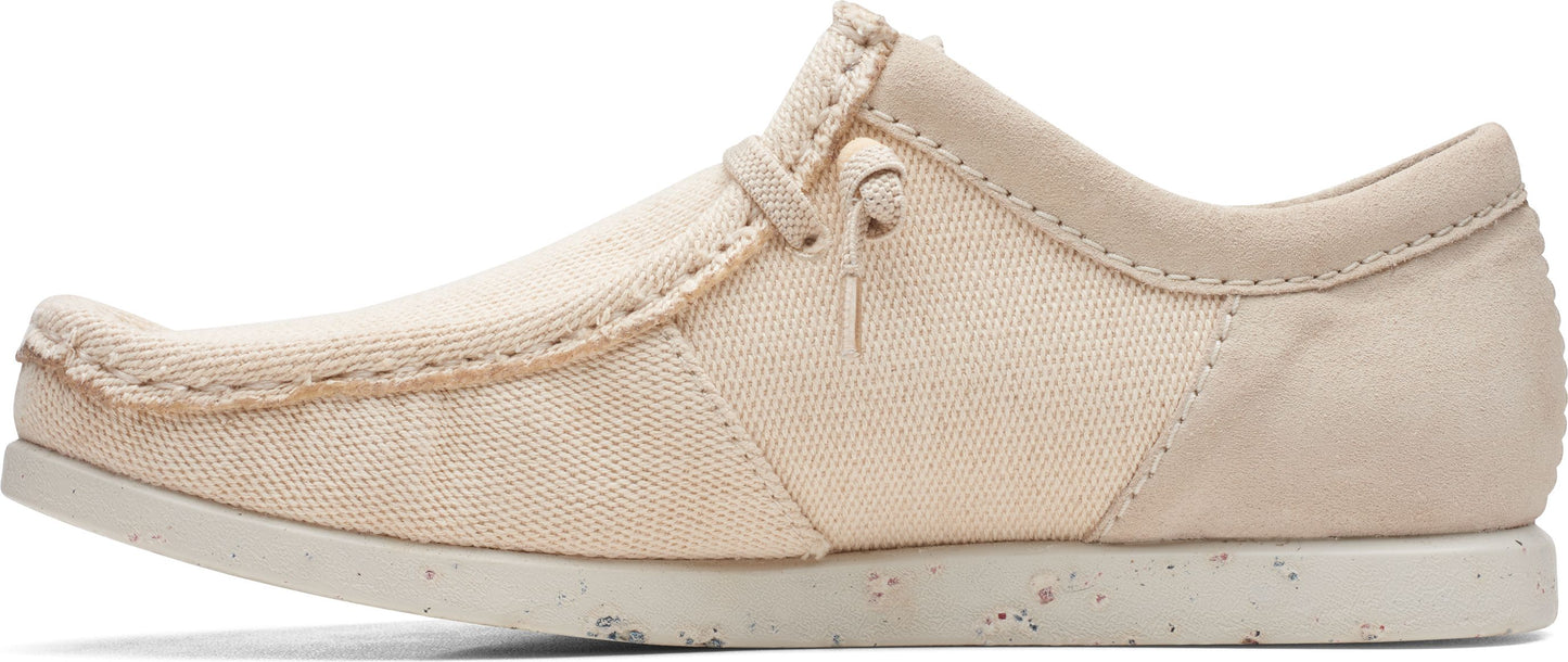 Beige moccasin-style slip-on shoe with a minimalist speckled sole.