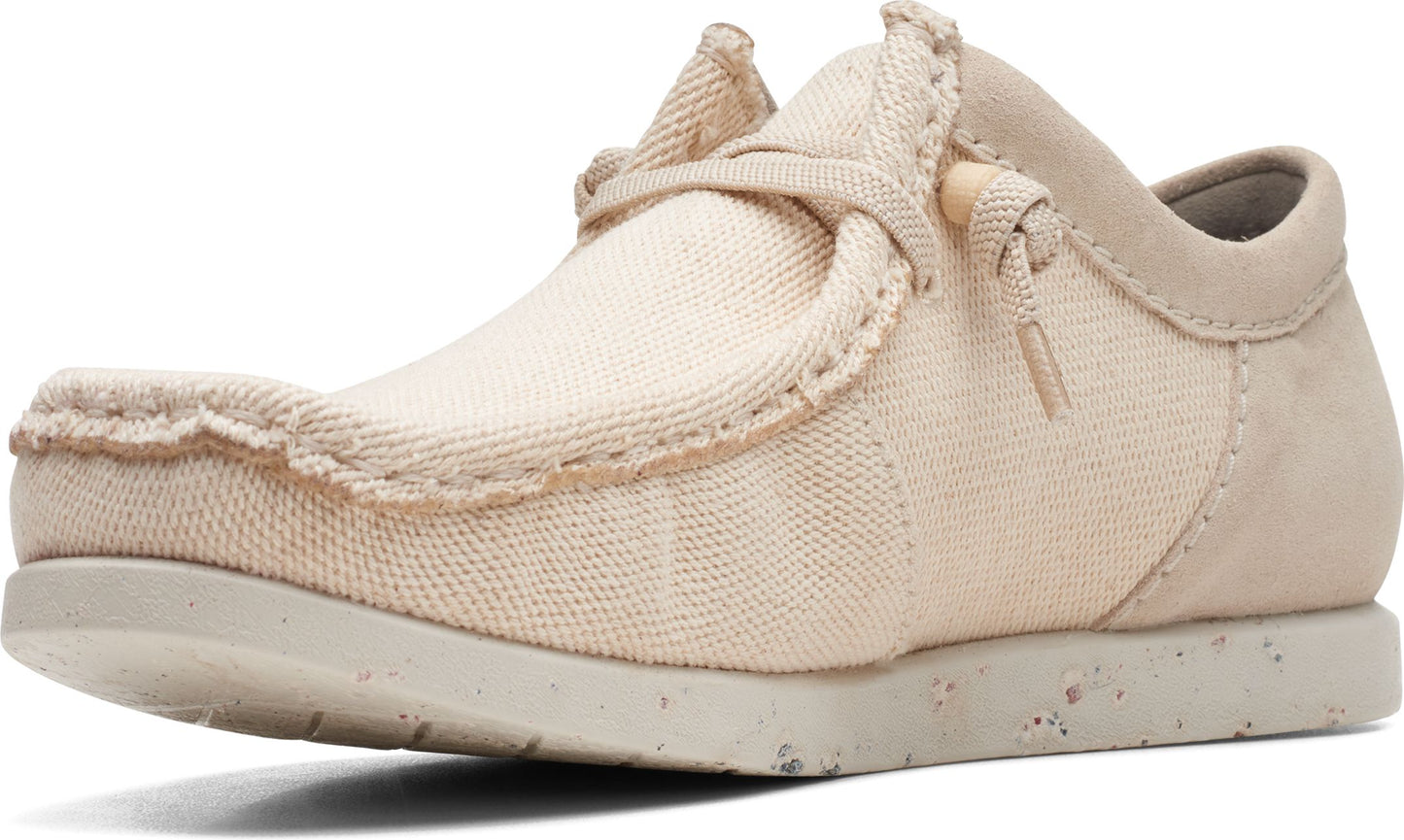 Beige casual shoe with textured fabric upper and tied laces.