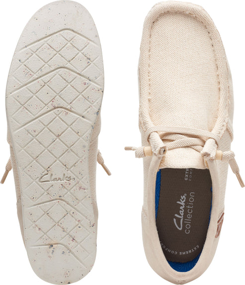 Beige moccasins with laces, showing sole with geometric pattern and interior with brand logo.