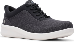 Low-top athletic shoe, black upper, black laces, black collar, white sole.