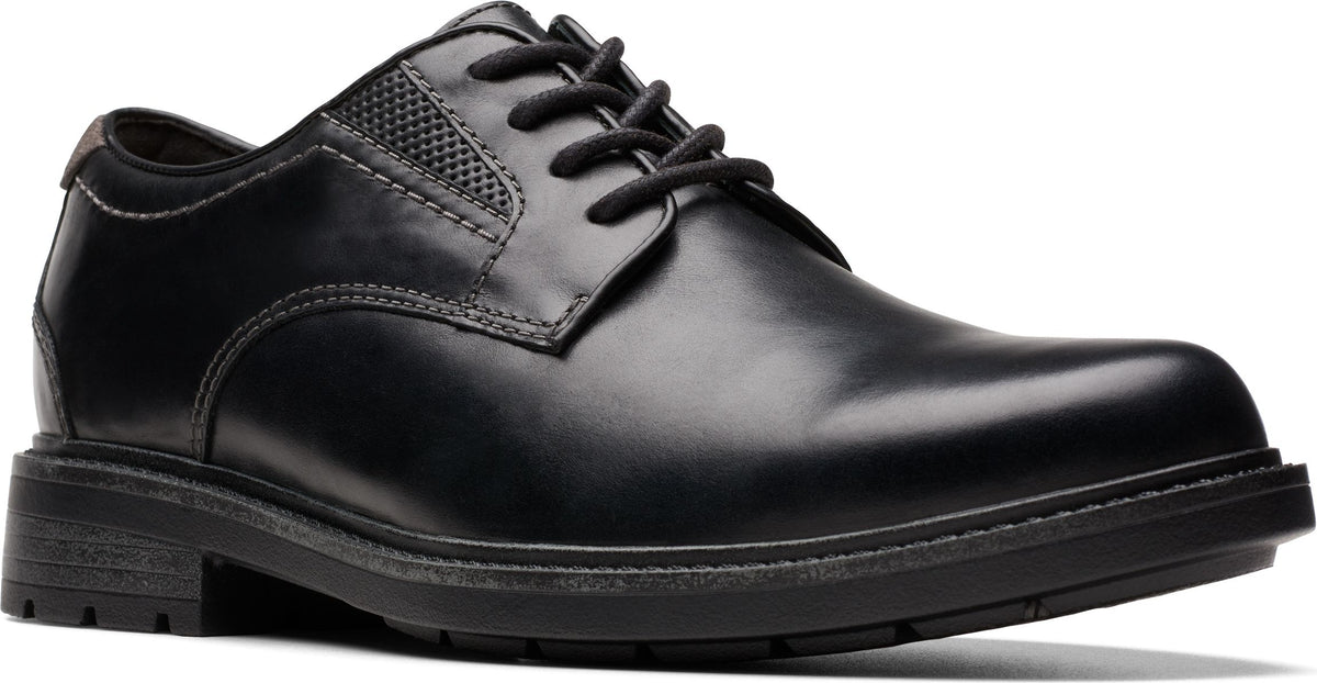 A black leather dress shoe with a lace-up closure and a low heel.