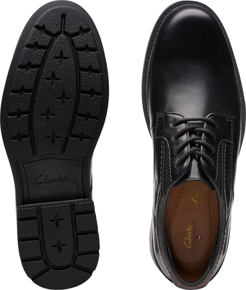 Black leather shoe pair: one sole view with deep treads, and one shoe view with lace-up closure.