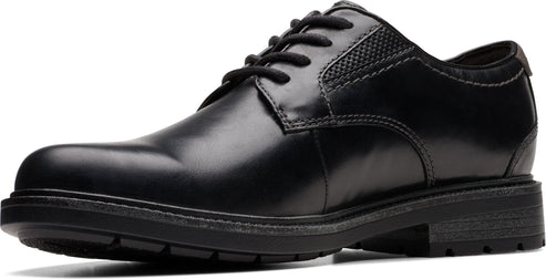 Black leather dress shoe with laces and textured detailing near the heel.