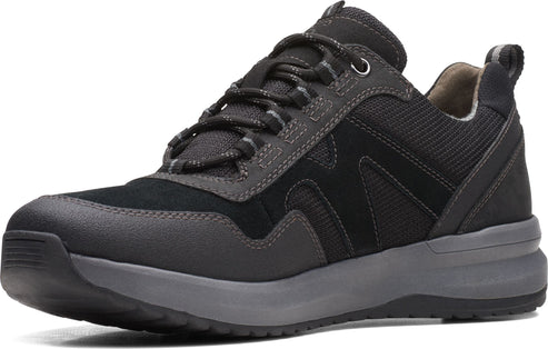 A black, low-cut hiking shoe with black laces and a gray sole.
