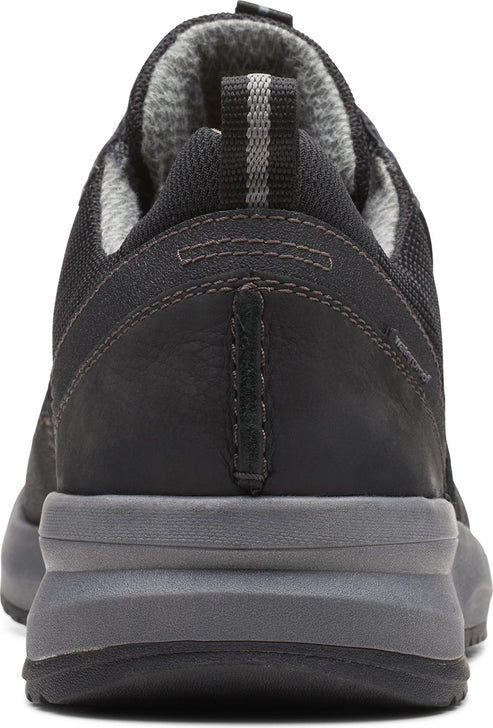 Back view of a black shoe with a gray sole and gray fabric lining.