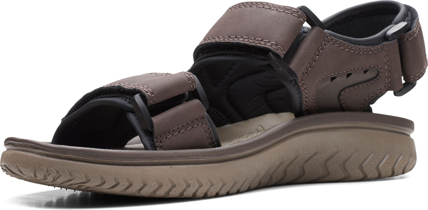 A brown sandal with velcro straps.