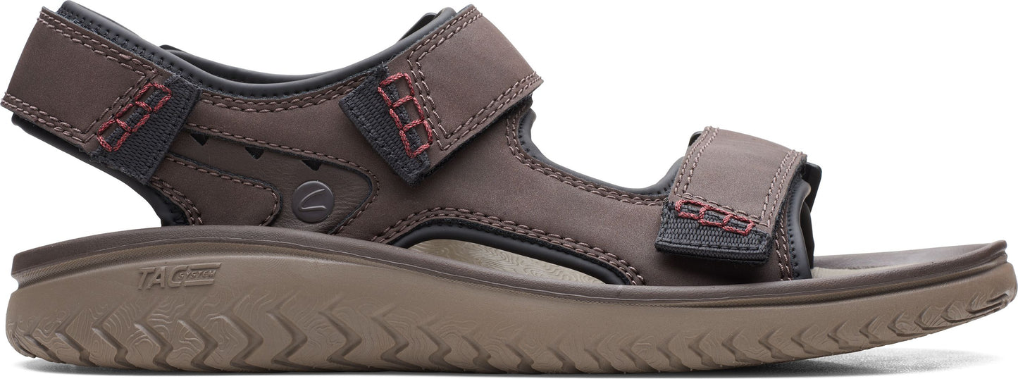 A brown sandal with two velcro straps.