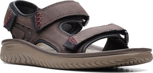 A brown sandal with hook-and-loop straps and red accent stitching.