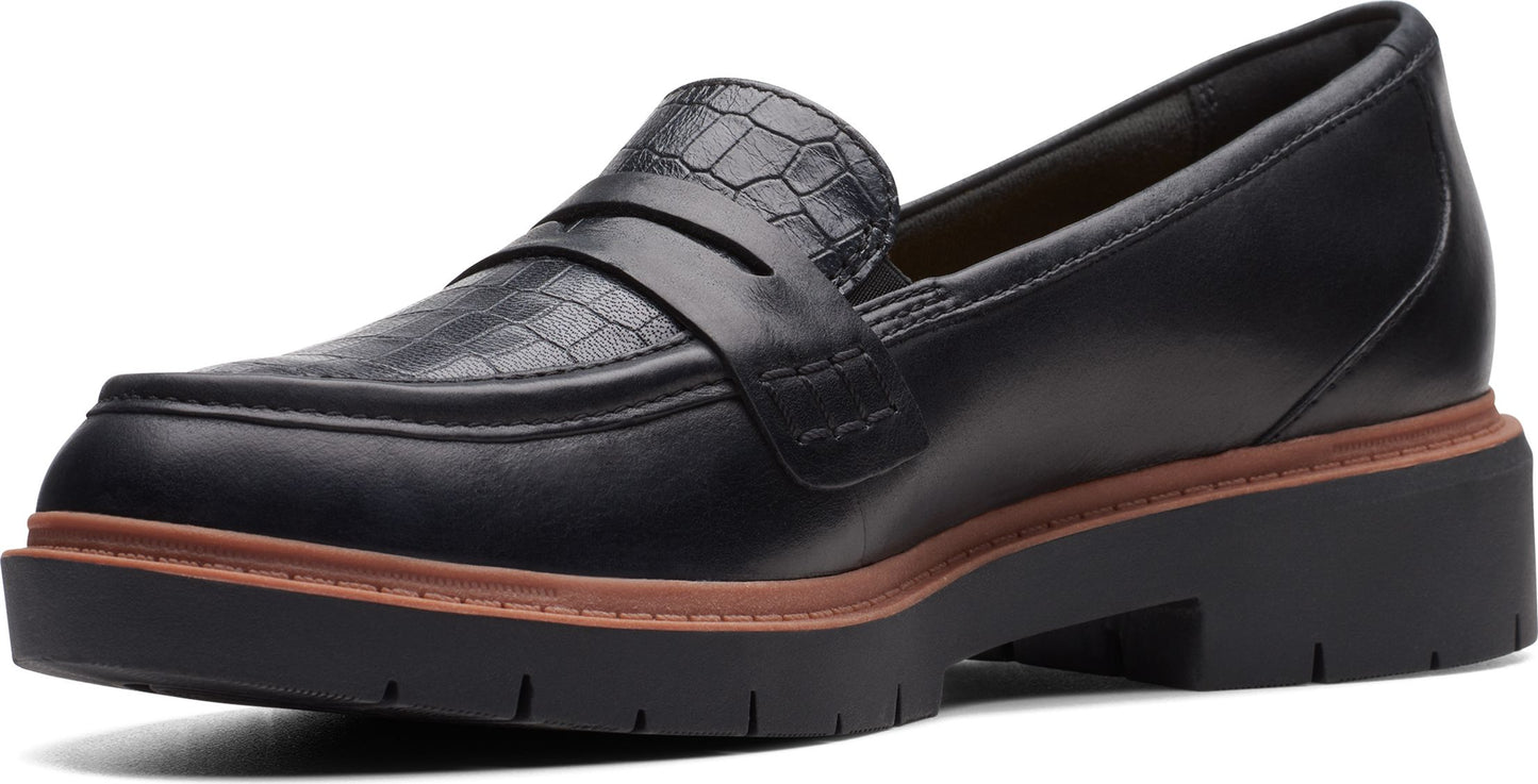 Black leather loafer with crocodile-patterned upper and chunky lug sole.
