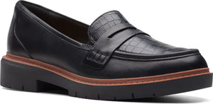 Black loafer with a lug sole and croc-embossed upper.